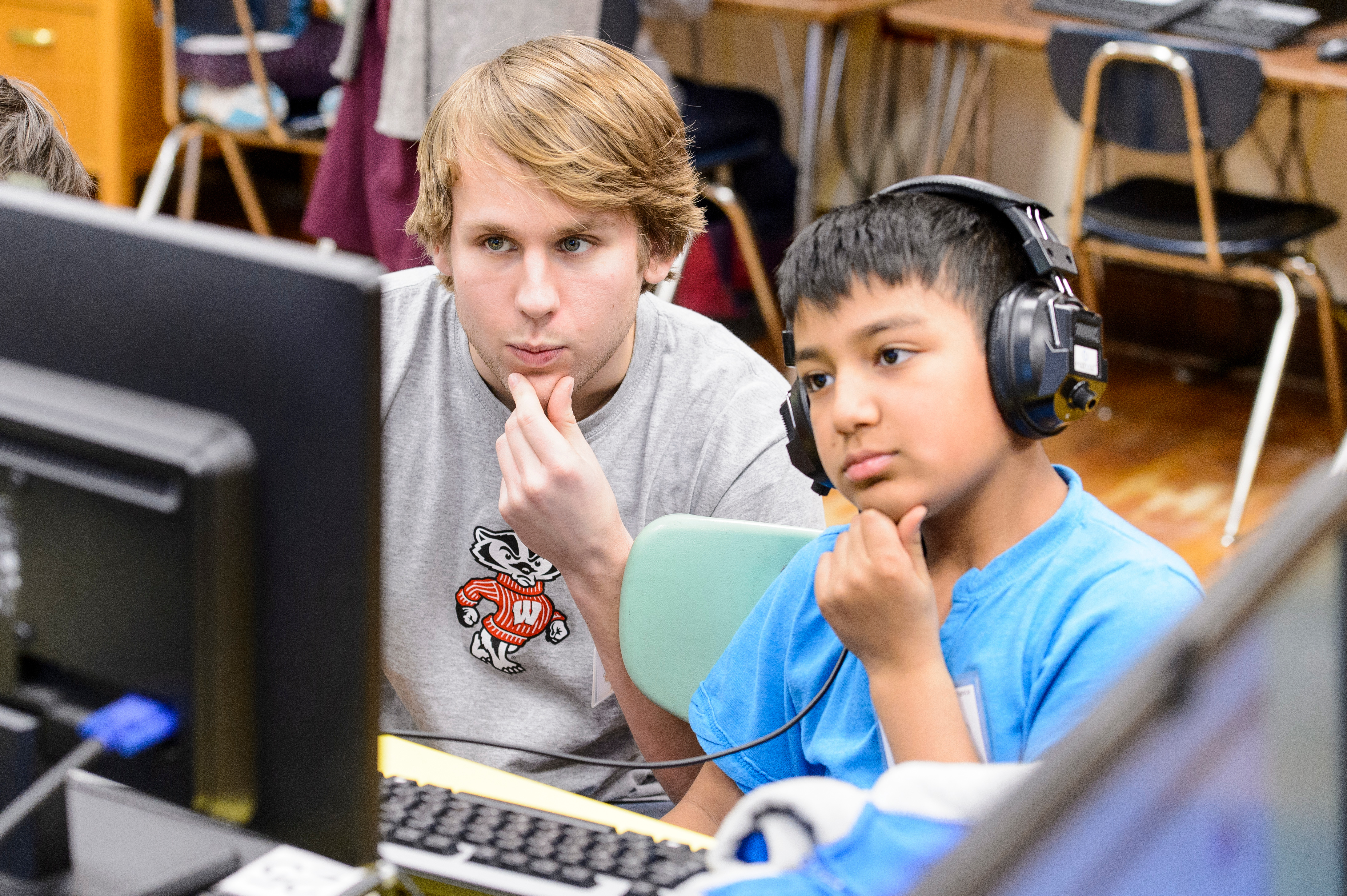 Researcher with child looking at computer