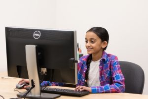 Participant looking at computer while smiling