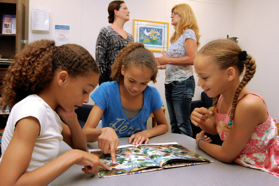 Participants look at a book together