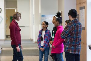 Photo of lab members greeting children.